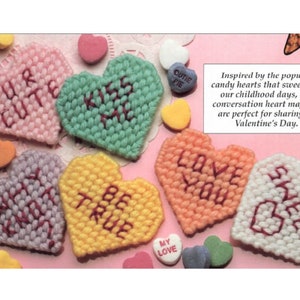 May include: A collection of colorful, heart-shaped magnets with embroidered messages like "UR CUTE" and "LOVE YOU." Inspired by candy hearts, these magnets are perfect for Valentine's Day. The magnets are in shades of pink, green, purple, yellow, orange, and white.