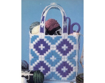 May include: A white and blue plastic canvas tote bag with a purple geometric pattern. The bag is filled with yarn and other craft supplies.
