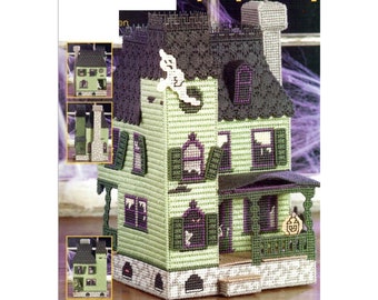 May include: A green and black plastic canvas model of a haunted house with a porch and a jack-o-lantern. The house has a black roof and white trim. The model is assembled in sections and can be used as a decoration.