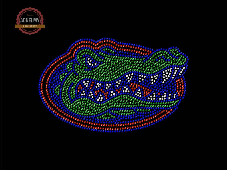 May include: A green, blue, and red alligator head design made of rhinestones. The design is on a black background.