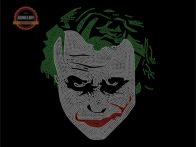 May include: A close-up of a rhinestone design of the Joker's face. The design is made up of white, green, and red rhinestones. The Joker's face is a classic image from the Batman comics and movies.