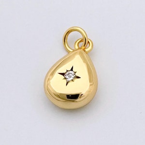May include: A gold teardrop-shaped pendant with a small diamond set in the centre.