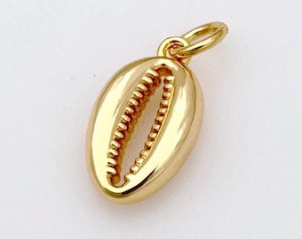 May include: Gold-coloured pendant shaped like a cowrie shell. The pendant has a smooth, rounded surface and a small loop at the top for attaching to a chain.