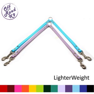 May include: A double dog leash with two clips on one end and a single clip on the other. The leash is made of two different colors of nylon, light blue and lavender. The leash is labeled "LighterWeight".