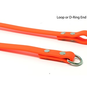 May include: Two orange rubber dog leashes with silver metal hardware. One leash has a loop end and the other has a D-ring end.  Loop or D-Ring End.