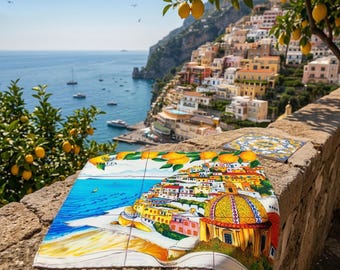 May include: A colorful tile set featuring a coastal Italian town scene with a blue sea, yellow buildings, and a golden-domed church. The tiles are displayed outdoors with a scenic view of the coast, lemon trees, and the sea.