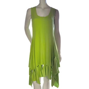 May include: A sleeveless, lime green dress with a scoop neckline and asymmetrical hemline. The dress features a flowing, layered design with cut-out details along the hem. The fabric appears soft and drapes loosely.