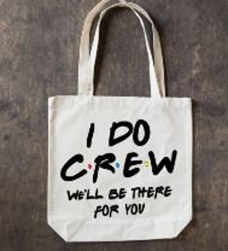 May include: White canvas tote bag with black text that reads "I DO CREW WE'LL BE THERE FOR YOU". The text is stylized to look like the Friends logo.
