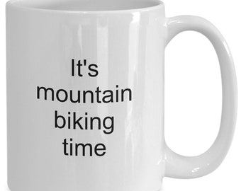 May include: White ceramic mug with a curved handle. The mug features the text "It's mountain biking time" in black, perfect for a cyclist. A great gift for a mountain biker.
