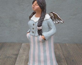 Angel with golden wings. Handmade ceramic sculpture.