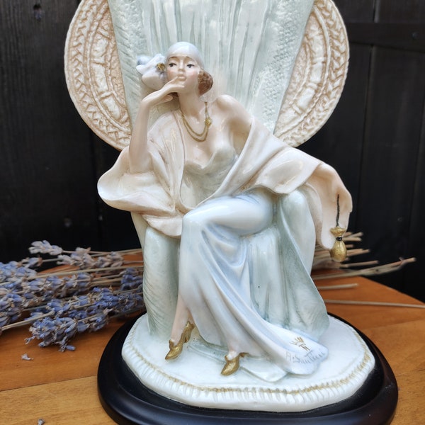 Pretty collectable art deco style figurine of a female sitting in a chair, signed Santini