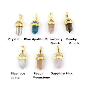 May include: Ten gold-plated crystal pendants with different coloured stones. The stones are: crystal, blue apatite, strawberry quartz, smoky quartz, blue lace agate, peach moonstone, sapphire pink, amethyst, rose quartz, and clear quartz.