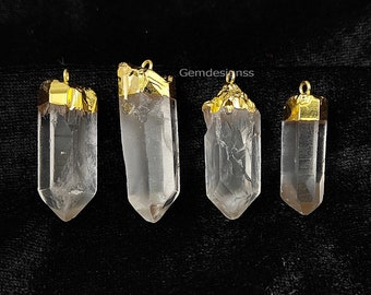 May include: Four clear quartz crystal pendants with gold-plated tops. The pendants are different sizes and shapes.