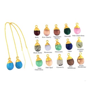 May include: A selection of gemstone earrings with gold-plated settings. The earrings are available in a variety of colours, including ruby, rose quartz, strawberry quartz, emerald, pink chalcedony, black rutile, moonstone, amazonite, lapis, dendrite opal, aqua chalcedony, pink opal, crystal quartz, grey moonstone, and peach moonstone.