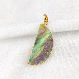May include: A gold pendant featuring a half-circle of iridescent abalone shell with a gold bail.