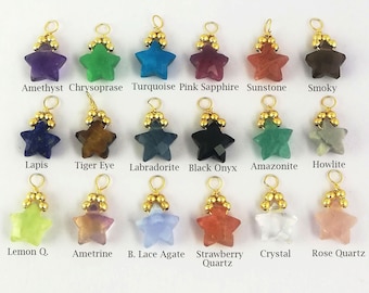 May include: Assortment of 18 gold-plated star-shaped gemstone pendants. Each pendant features a different gemstone, including amethyst, chrysoprase, turquoise, pink sapphire, sunstone, smoky, lapis, tiger eye, labradorite, black onyx, amazonite, howlite, lemon quartz, ametrine, blue lace agate, strawberry quartz, crystal, and rose quartz.