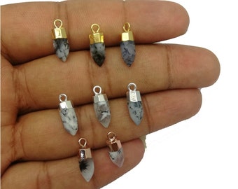May include: Eight silver, gold, and rose gold pendant charms with a white and black dendritic agate stone. The charms are in the shape of a point or a teardrop.