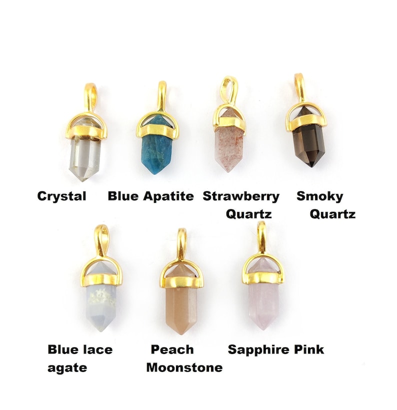 May include: Ten gold-plated crystal pendants with different coloured stones. The stones are: crystal, blue apatite, strawberry quartz, smoky quartz, blue lace agate, peach moonstone, sapphire pink, amethyst, rose quartz, and clear quartz.