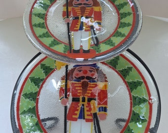 Peggy Karr Nutcrackers 11&quot; & 8&quot; plates in two tiered wrought iron stand.