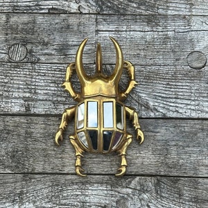 8-sided patinated gold mirror beetle 24x15 cm