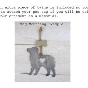 May include: A metal dog silhouette ornament with a heart cut out and a bone-shaped tag hanging from it. The ornament is attached to a piece of twine. The text "Tag Mounting Example" is written above the ornament.
