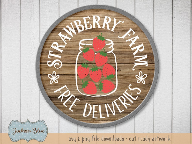 May include: A round wooden sign with a gray border, featuring the text "Strawberry Farm" in white lettering. The sign also includes the text "Free Deliveries" in white lettering and a graphic of a mason jar filled with red strawberries.