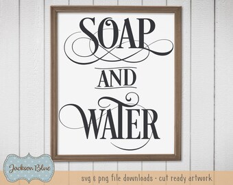 May include: A framed print featuring the words "SOAP AND WATER" in black script on a white background. The frame is brown. The artwork is a digital download, suitable for home decor.
