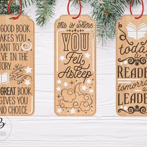May include: Three wooden bookmarks with inspirational quotes about reading. The first bookmark says "A good book makes you want to live in the story. A great book gives you no choice." The second bookmark says "This is where you fell asleep." The third bookmark says "Today a reader, tomorrow a leader."