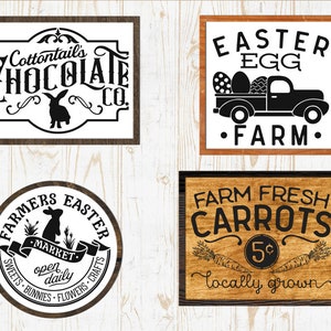 May include: Four wooden signs with black text and graphics. The first sign says "Cottontail's Chocolate Co." with a rabbit silhouette. The second sign says "Easter Egg Farm" with a black truck carrying eggs. The third sign says "Farmers Easter Market" with a rabbit silhouette and the text "open daily". The fourth sign says "Farm Fresh Carrots 5&cent; locally grown" with a carrot graphic.