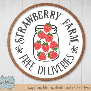 May include: A white round sign with a brown wooden frame. The sign says "Strawberry Farm" with a jar of strawberries in the center and the words "Free Deliveries" around the bottom.
