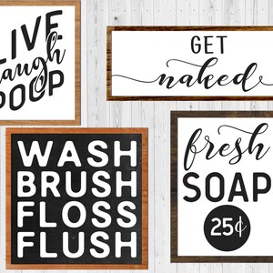 May include: Four wooden framed signs with white backgrounds and black lettering. The signs read "Live Laugh Poop", "Get Naked", "Wash Brush Floss Flush", and "Fresh Soap 25&cent;".