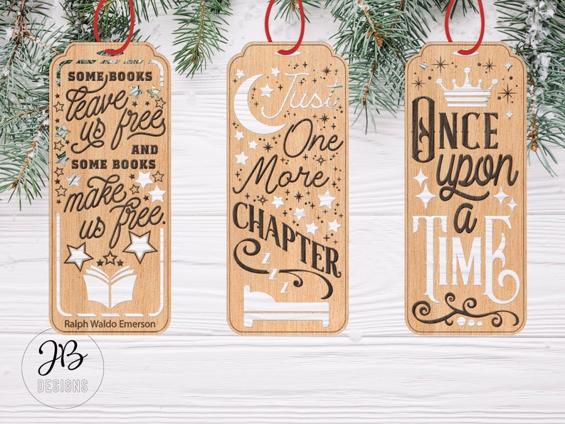 May include: Three wooden bookmarks with different quotes. The first bookmark says "Some books leave us free and some books make us free." The second bookmark says "Just one more chapter." The third bookmark says "Once upon a time."
