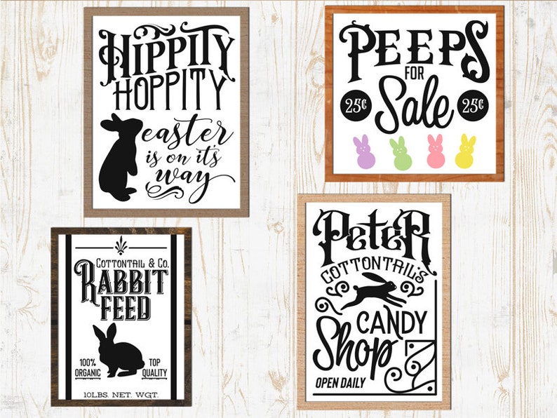 May include: Four wooden signs with black text and images. The top left sign says "Hippity Hoppity Easter is on its way" with a black rabbit silhouette. The top right sign says "Peeps for 25c Sale 25c" with three pastel colored peeps. The bottom left sign says "Cottontail & Co. Rabbit Feed 100% Organic Top Quality 10lbs Net. Wgt." with a black rabbit silhouette. The bottom right sign says "Peter Cottontails Candy Shop Open Daily" with a black rabbit silhouette.