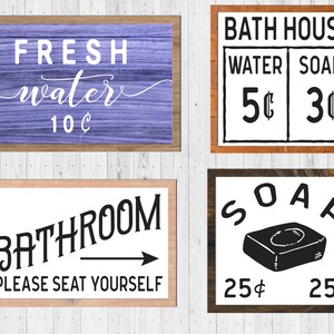 May include: Four vintage-style wooden signs with black text. The top left sign is purple and says "FRESH water 10&cent;". The top right sign says "BATH HOUSE" with a price list for "WATER 5&cent;" and "SOAP 3&cent;". The bottom left sign says "BATHROOM PLEASE SEAT YOURSELF" with a black arrow pointing to the right. The bottom right sign says "SOAP" with a black and white illustration of a bar of soap and the price "25&cent;" on each side.