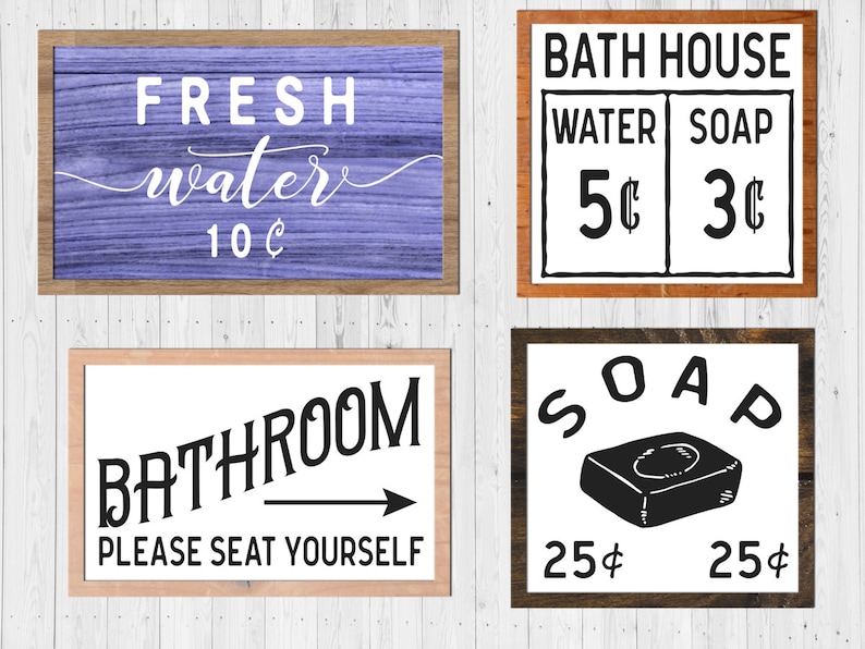 May include: Four vintage-style wooden signs with black text. The top left sign is purple and says "FRESH water 10&cent;". The top right sign says "BATH HOUSE" with a price list for "WATER 5&cent;" and "SOAP 3&cent;". The bottom left sign says "BATHROOM PLEASE SEAT YOURSELF" with a black arrow pointing to the right. The bottom right sign says "SOAP" with a black and white illustration of a bar of soap and the price "25&cent;" on each side.