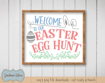 May include: A white sign with a wooden frame, featuring the text "Welcome to our Easter Egg Hunt" in blue, gray, and pink lettering. The sign is decorated with a green vine and a gray egg with a white pattern.