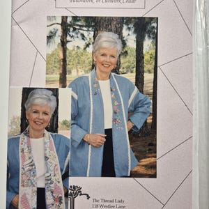 May include: A sewing pattern envelope titled Shawl Collar Jacket for Silk Ribbon Embroidery, Patchwork or Cutwork Collar. The cover features two photographs of a light blue jacket with floral embroidery and a patchwork collar design.