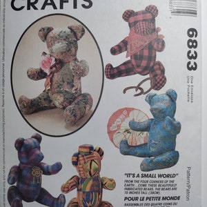 May include: A sewing pattern for making four different teddy bears. The pattern is called "It's a Small World" and includes instructions for making bears 15 inches tall. The bears are shown in various fabrics and colors, including red and black plaid, blue and white floral, and a colorful African print.