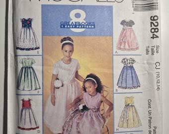 McCall's 9284, 8 girls dress variations with double layer skirt, sizes 10,12,14, uncut and factory folded, see description and photos C.1998