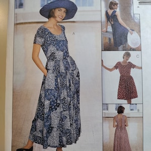 May include: A sewing pattern for a dress with three different styles. The pattern is from McCall's and is part of the Woman's Day Collection. The dress is shown in three different fabrics: a blue and white floral print, a solid blue, and a red and white gingham.