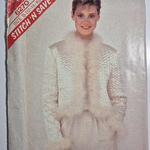 May include: A vintage sewing pattern cover featuring a woman wearing a white jacket and pants. The jacket has a textured pattern and is trimmed with fluffy feathers at the collar, cuffs, and hem. The text "STITCH 'N SAVE" is visible.