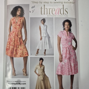 May include: Simplicity sewing pattern featuring a magazine collection. The pattern includes images of dresses in various colors and styles, with the text "threads" and "Step by step to sewing success!"