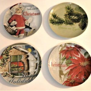 May include: Set of four round ceramic plates with vintage Christmas designs. The plates feature a child carrying a basket of gifts, a bird's nest in a pine tree, a snowy house with a window, and a red poinsettia flower.