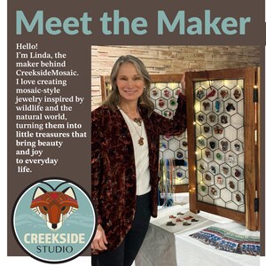Photo shows artist Linda Webb with a collection of her mosaic pendant designs.