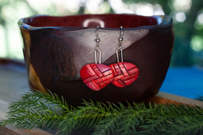 Photo shows bright red dangle mosaic earrings in an inverted triangle shape. The wires are shiny Sterling silver.