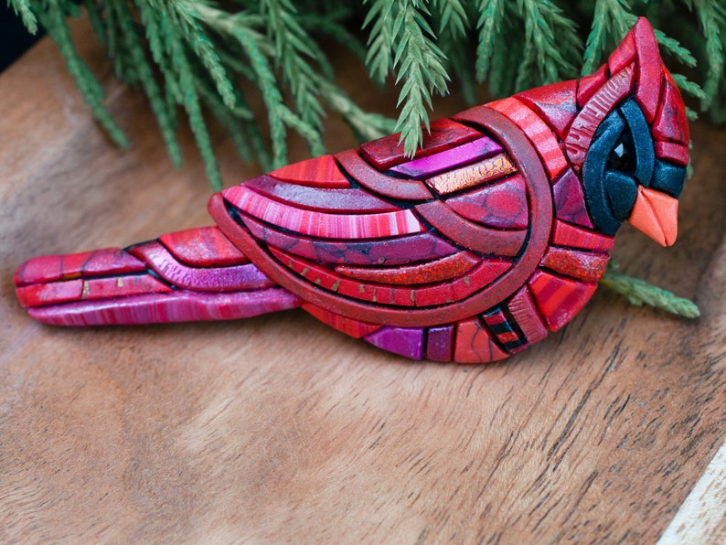 Photo shows the intricate details of a red male cardinal brooch.