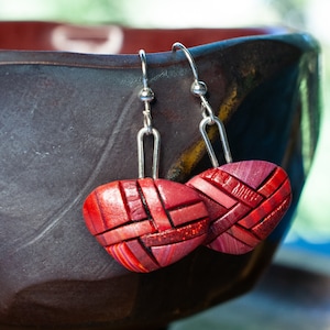 Photo shows bright red dangle mosaic earrings in an inverted triangle shape. The wires are shiny Sterling silver.