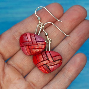 Photo shows bright red dangle mosaic earrings in an inverted triangle shape. The wires are shiny Sterling silver.