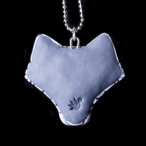 Photo shows the gray back with makers mark stamped in the center.