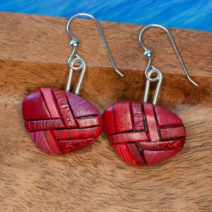 Photo shows bright red dangle mosaic earrings in an inverted triangle shape. The wires are shiny Sterling silver.